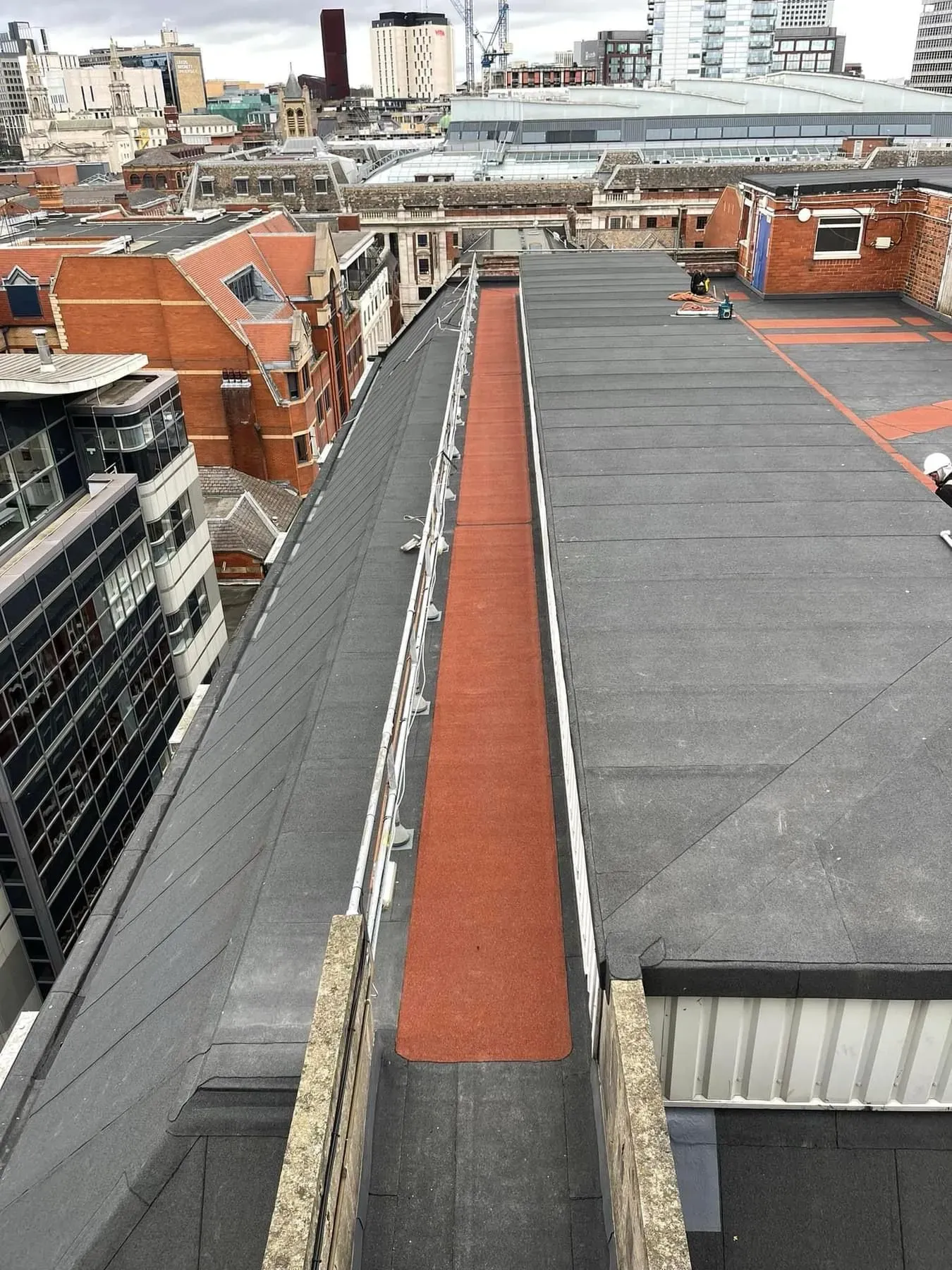 Large flat roof on a commercial building, showing different flat roofing sections