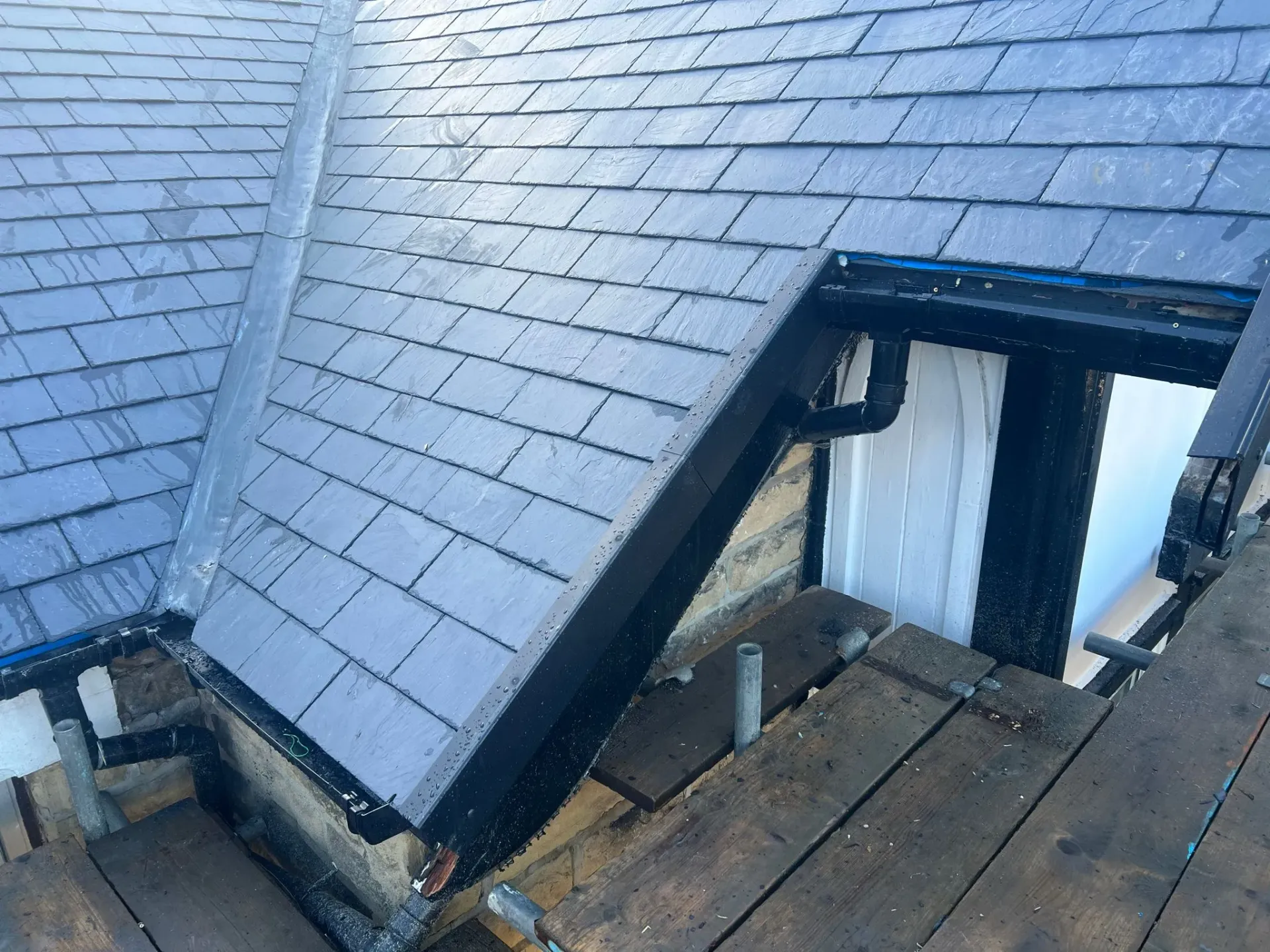 Slate pitched roof repair or installation with lead valley and guttering