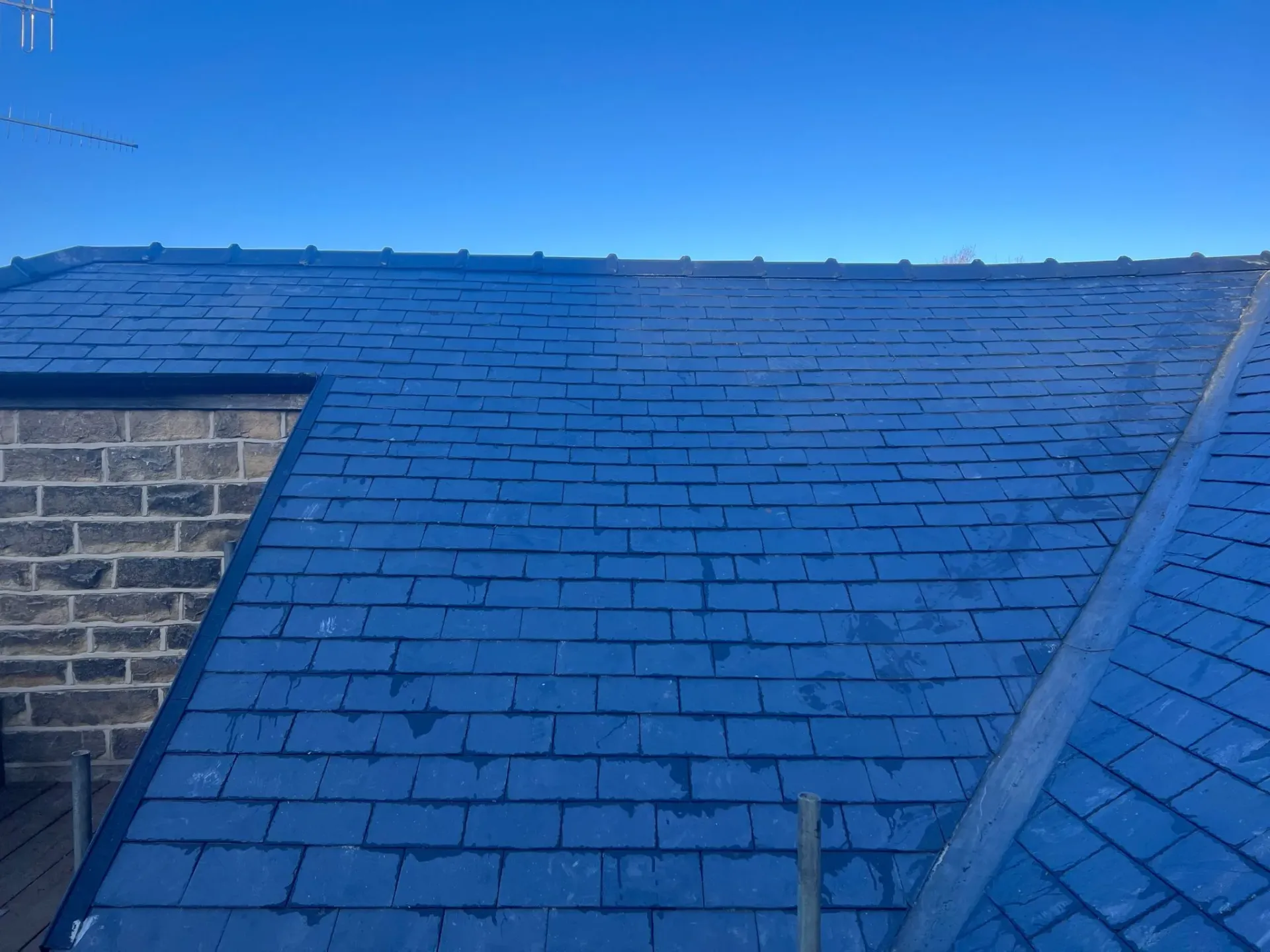 Newly installed or repaired slate roof tiles on a pitched roof in Sheffield or the Peak District by Alliance Roofing Services.