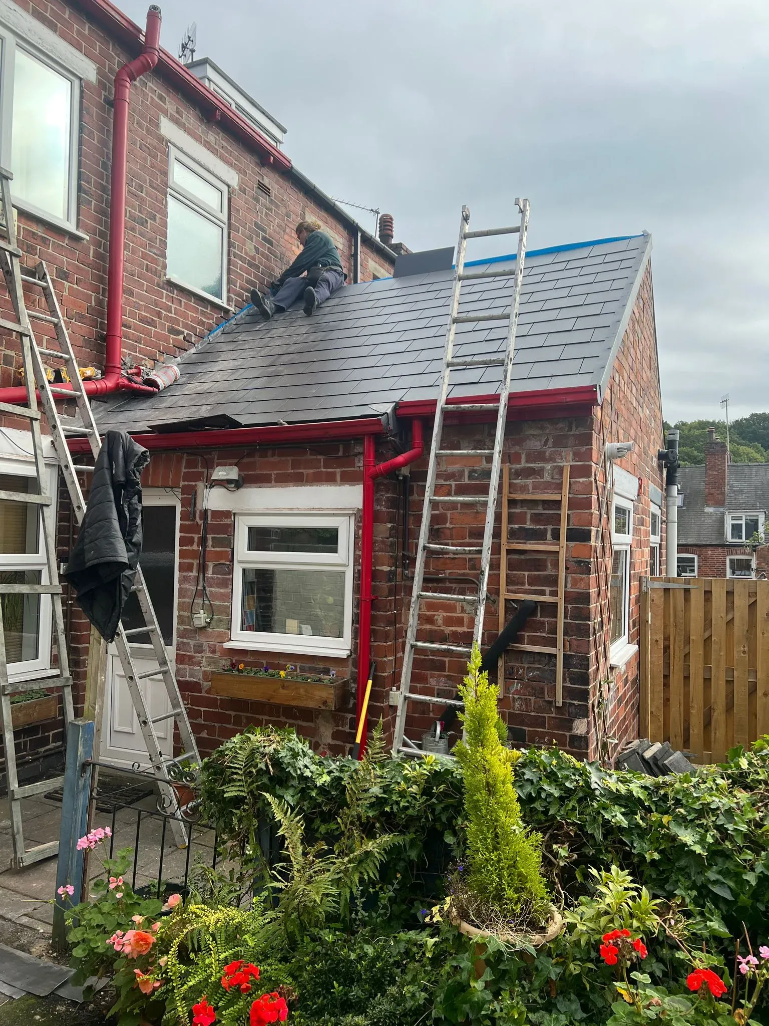 Alliance Roofing Services expert roofer installing tiles on a pitched roof extension in Sheffield or the Peak District.