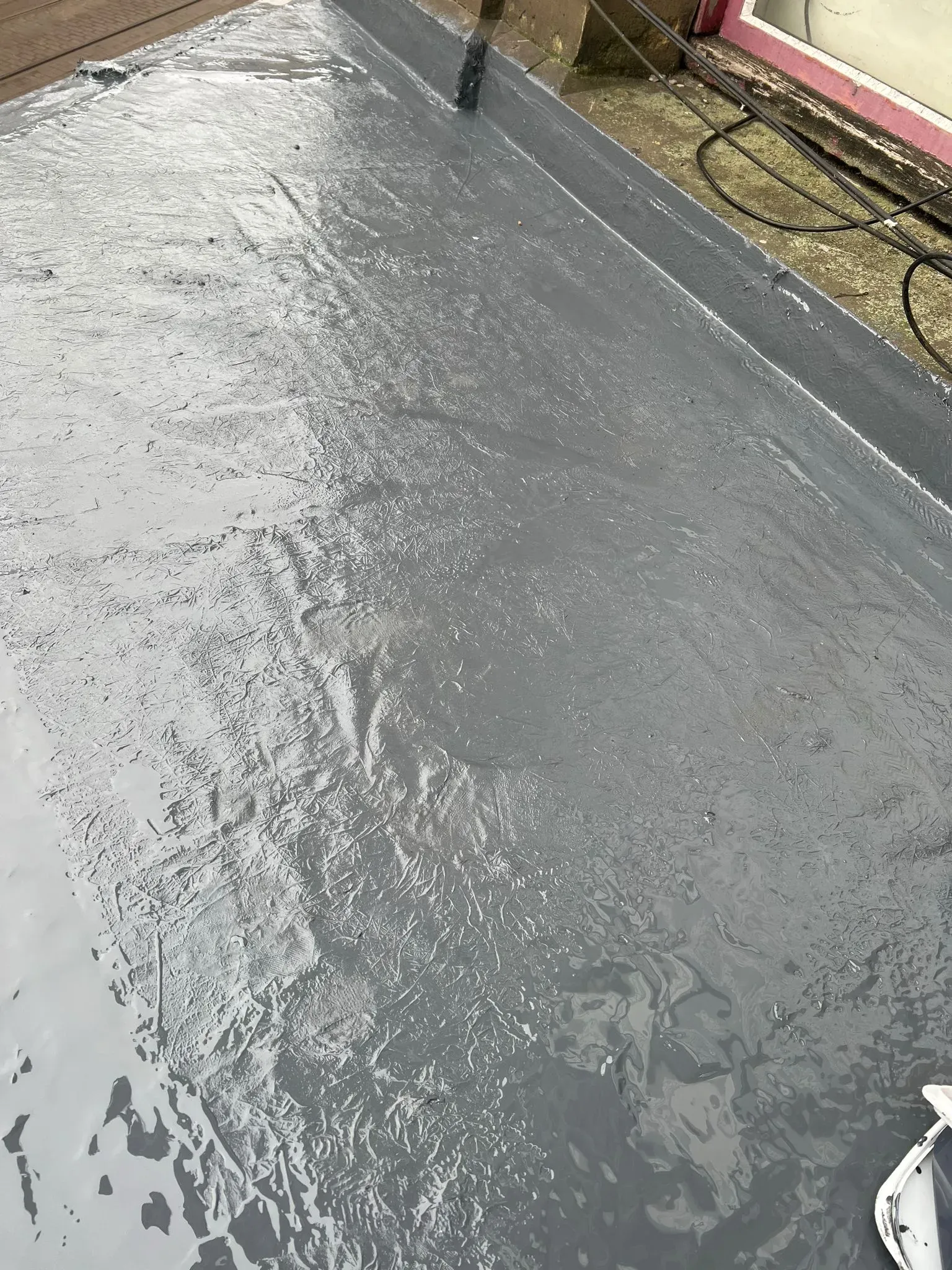 Applying waterproof coating to a flat roof