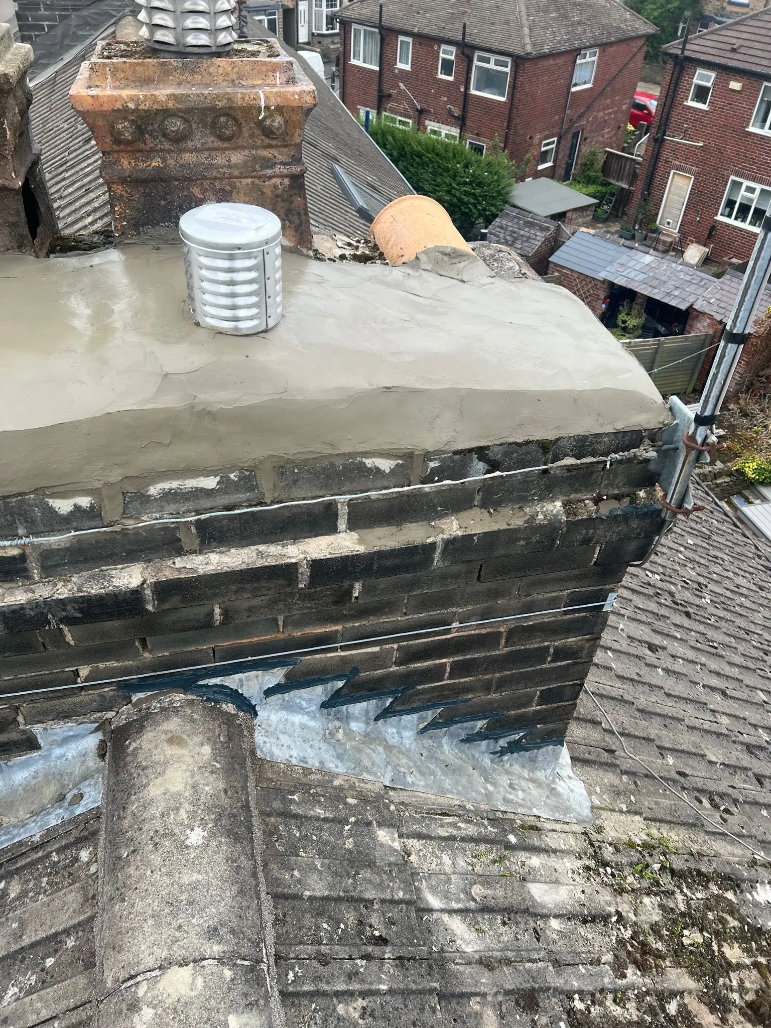 A repaired chimney stack on a house roof.