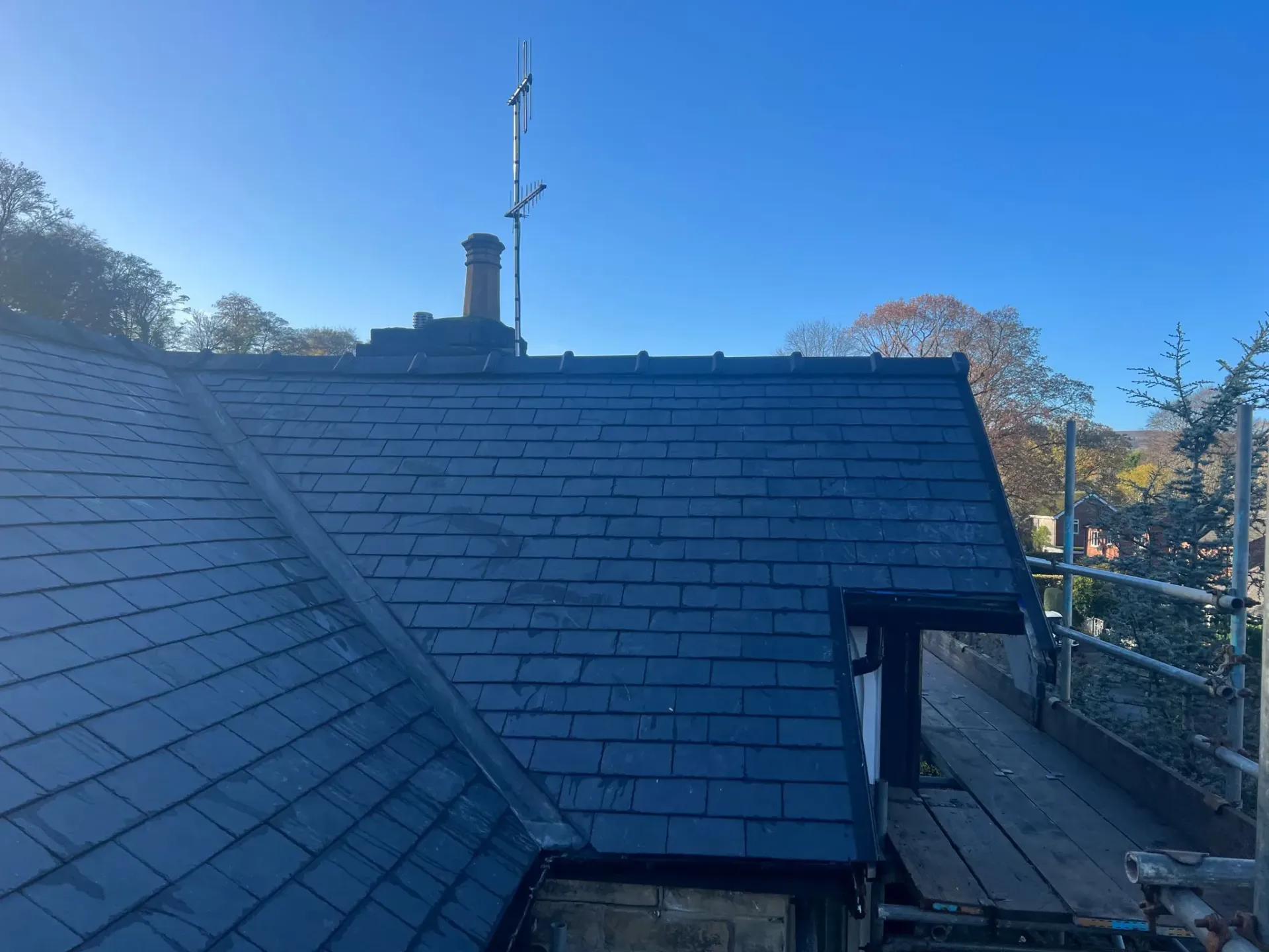 New slate roof tiles with lead work and chimney