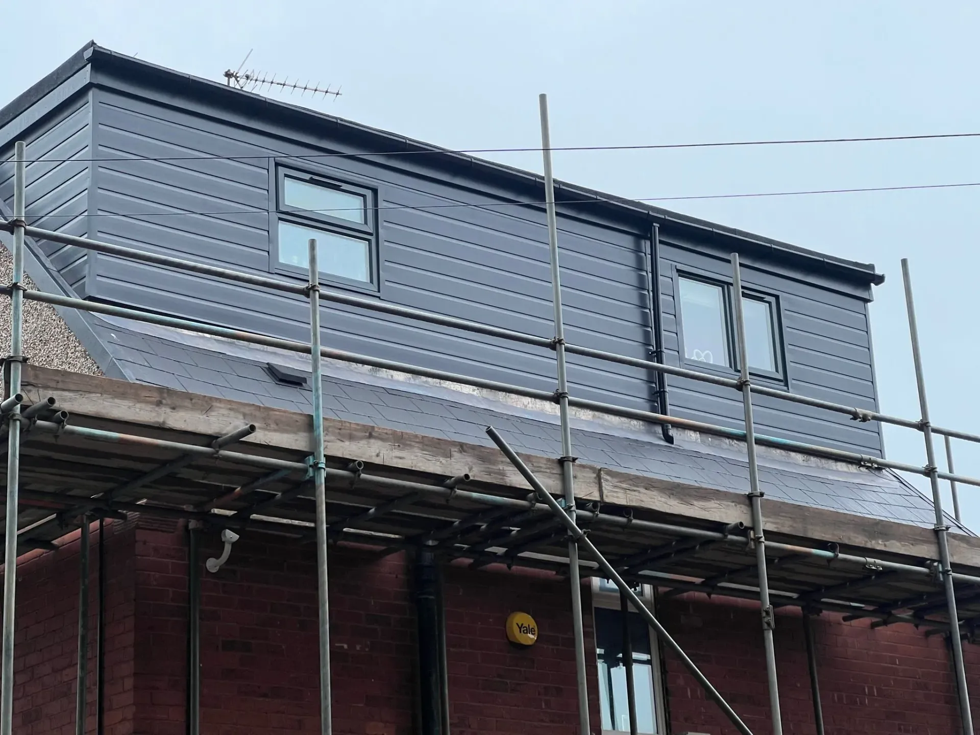 A picture of a house with a new dormer roof extension and scaffolding.