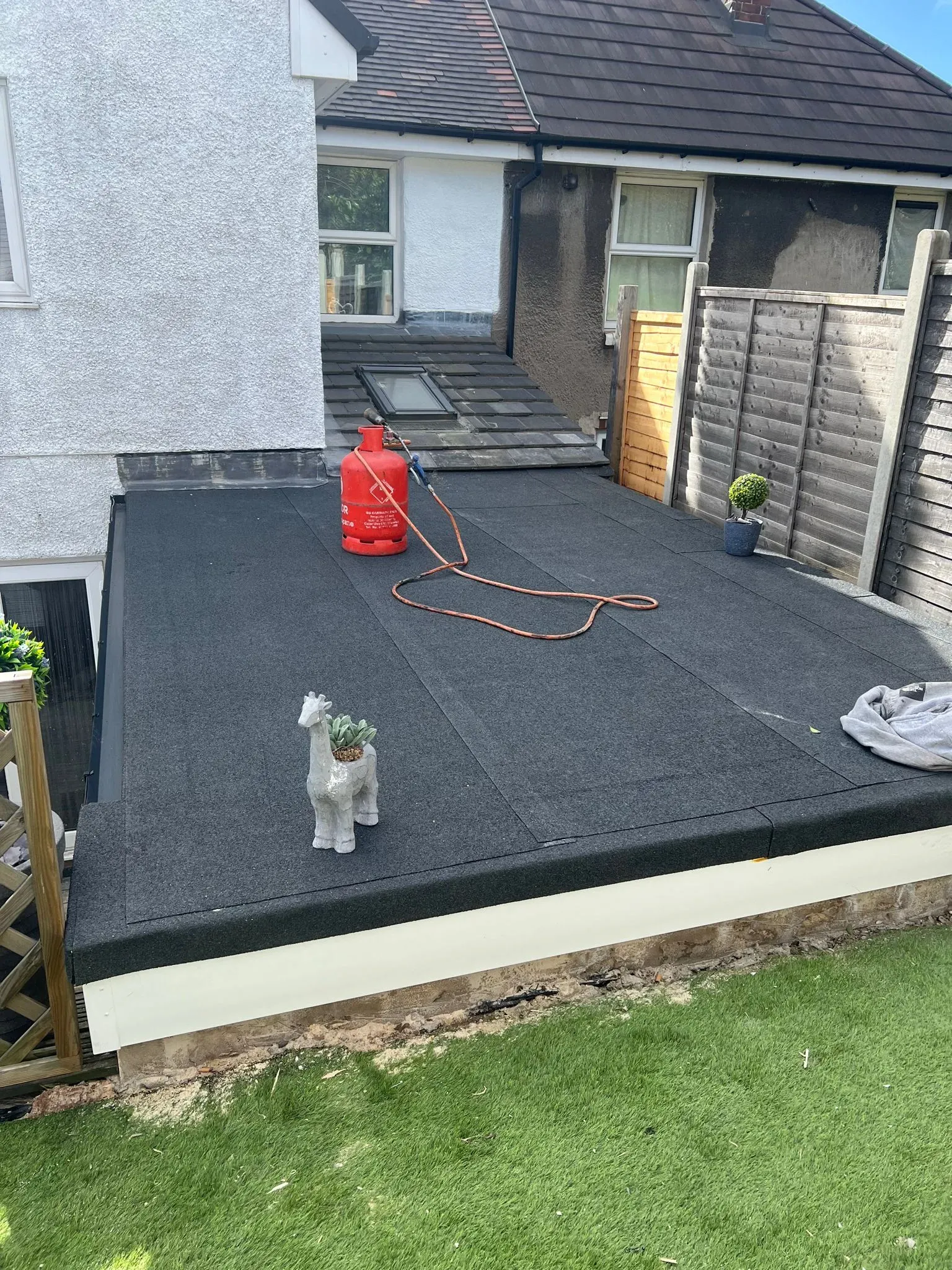 New felt flat roof installation on a house extension.